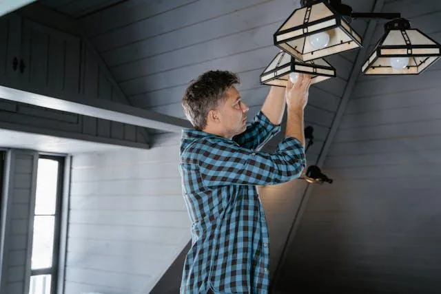 Person changing a light bulb
